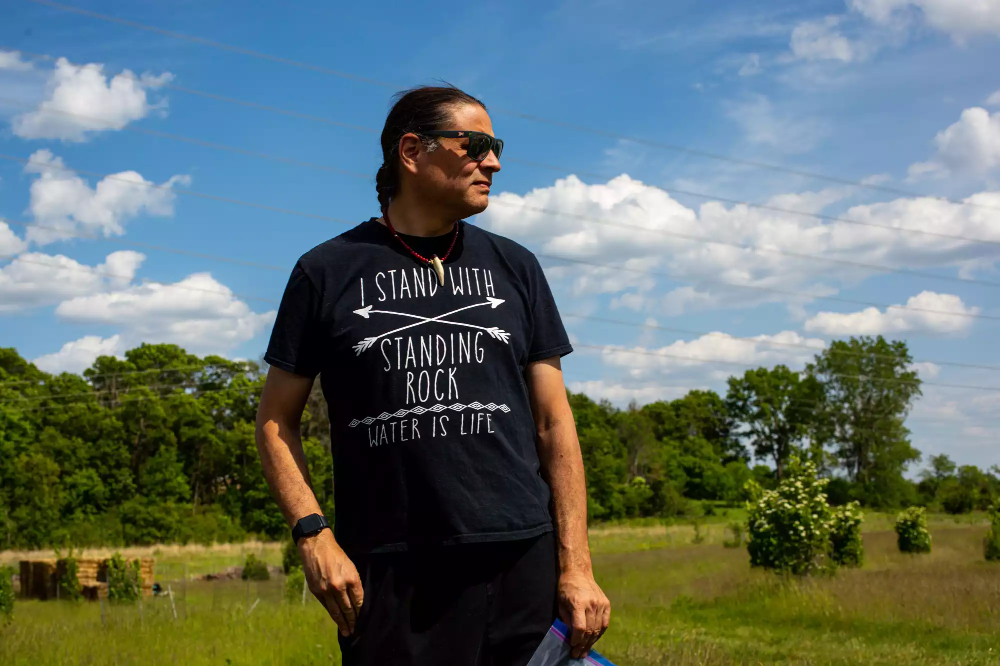 Sean Sherman wearing t-shirt "I stand with standing rock - water is life"